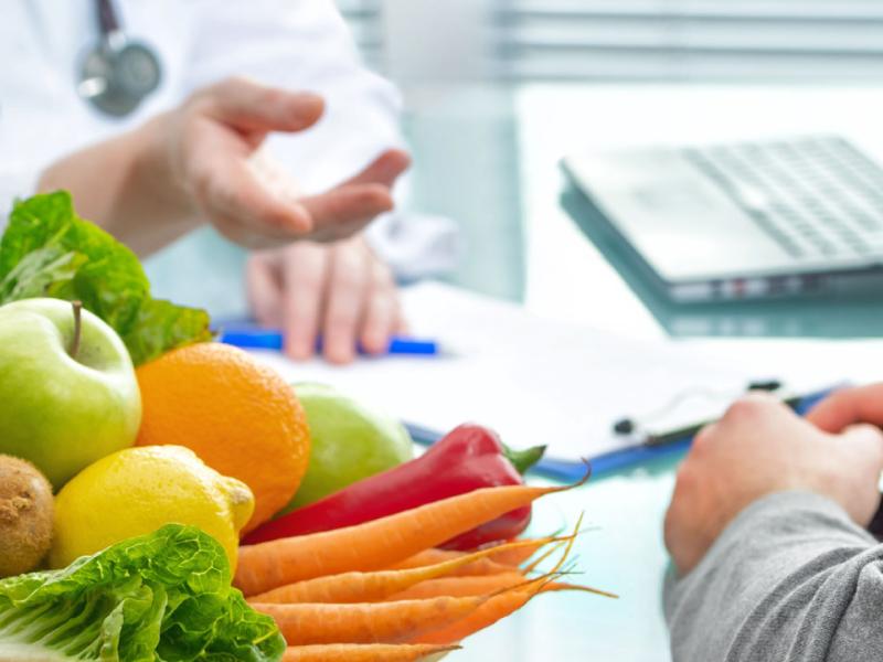 Doctor Pointing Towards Fresh Vegetables and Juices. 